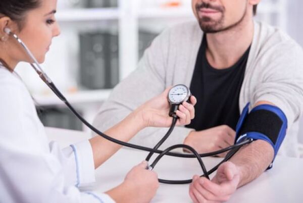 the doctor measures blood pressure in hypertension